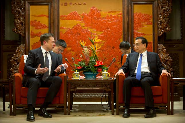Tesla CEO Elon Musk (L) speaks as Chinese Premier Li Keqiang listens  during a meeting at the Zhongnanhai leadership compound in Beijing on  January 9, 2019.