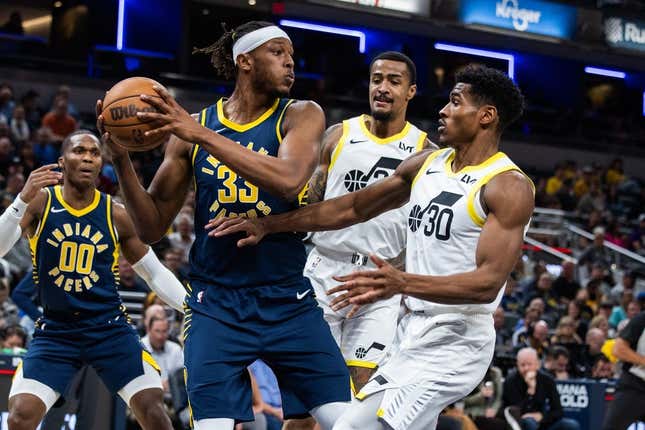 Nov 8, 2023; Indianapolis, Indiana, USA; Indiana Pacers center Myles Turner (33) rebounds the ball while Utah Jazz guard Ochai Agbaji (30) defends in the first quarter at Gainbridge Fieldhouse.