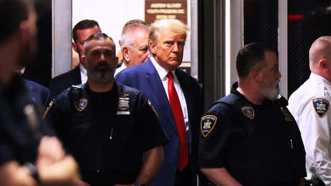 Trump enters a court room in April 2023 during his first indictment in Manhattan Criminal Court.