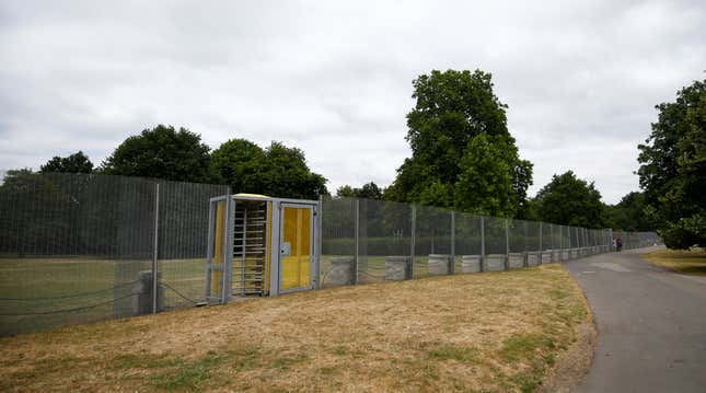 Visitors to the park use a special gate to pass through fences, that have been erected before the U.S. presidential visit at the end of the week, around the U.S. ambassador's residence in Regent's Park in London, Britain, July 10, 2018. REUTERS/Henry Nicholls - RC162E9F4960