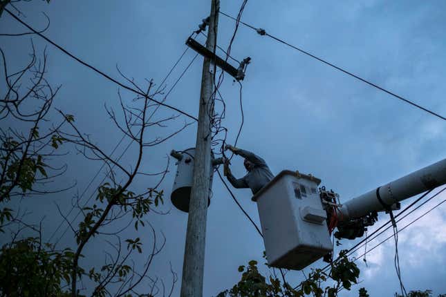 FILE - A worker from the Puerto Rico Power Authority works to restore power in Adjuntas, Puerto Rico, July 12, 2018. A key hearing over the future of Puerto Rico’s crumbling power company and its $9 billion debt began on March 4, 2024, in federal court following years of talks between the U.S. territory&#39;s government and creditors seeking to recover their investments. (AP Photo/Dennis M. Rivera Pichardo, File)