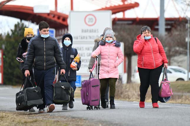 Ukrainian refugees cross the border by foot in Barabas, Hungary, on February 28, 2022. 