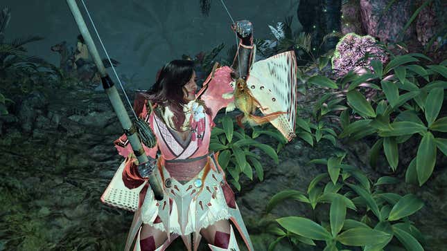 A Hunter holds a Goldenfry fish after catching it in the Scarlet Forest.