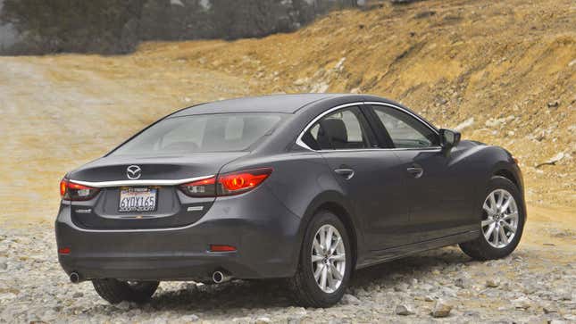 A photo of the rear end on a silver Mazda 6 sedan. 