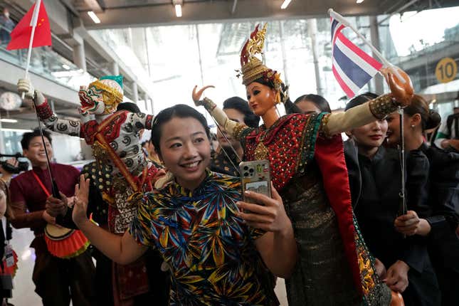 Chinese tourists dance with puppet as they are welcomed on arrivals at Suvarnabhumi International Airport in Samut Prakarn province, Thailand, Monday, Sept. 25, 2023. Thailand&#39;s new government granting temporary visa-free entry to Chinese tourists, signaling that the recovery of the country&#39;s tourism industry is a top economic priority. (AP Photo/Sakchai Lalit)