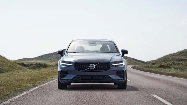 A gray Volvo S60 driving straight at the camera on a rural road