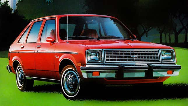 A photo of a red Chevrolet Chevette hatchback parked on grass. 