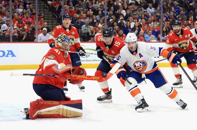 SUNRISE, FLORIDA - MARCH 28: Anthony Stolarz #41 of the Florida Panthers makes the third period save as Cal Clutterbuck #15 of the New York Islanders looks for the rebound at Amerant Bank Arena on March 28, 2024 in Sunrise, Florida. (Photo by Bruce Bennett/Getty Images)