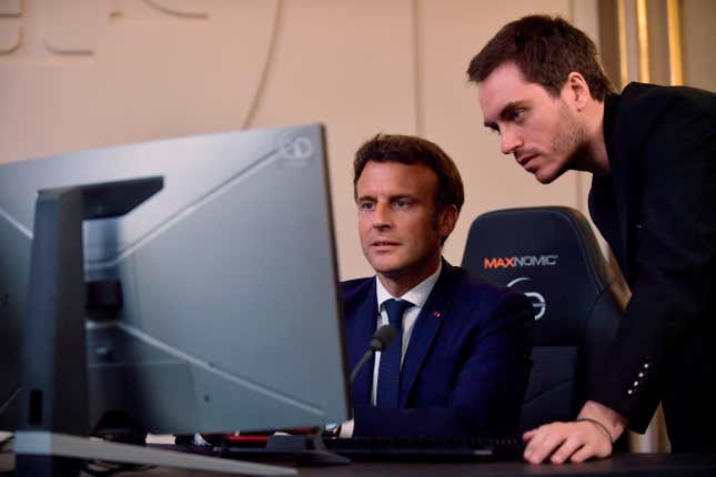 FILE - French President Emmanuel Macron plays a video game next to Adrien Nougaret, aka ZeratoR, during a meeting with French esport video game players at the Elysee Palace in Paris, Friday June 3, 2022. French President Emmanuel Macron is extending an olive branch to video gamers after previously linking video games to riots that rocked France this year. Posting on the platform previously known as Twitter, Macron backpedalled on remarks where he had blamed video games for having “intoxicated” some young rioters. (Julien de Rosa, Pool via AP, File)