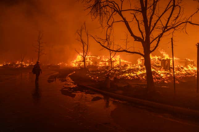 Firefighters battle the Eaton Fire in strong winds as many homes burn on January 7, 2025 in Pasadena, California.