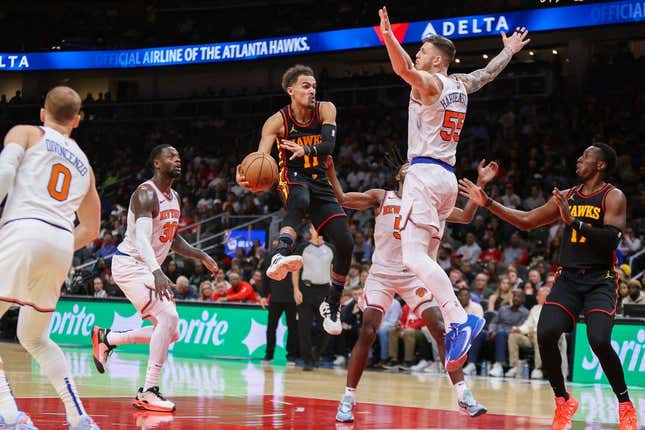 Nov 15, 2023; Atlanta, Georgia, USA; Atlanta Hawks guard Trae Young (11) passes around New York Knicks center Isaiah Hartenstein (55) in the second half at State Farm Arena.