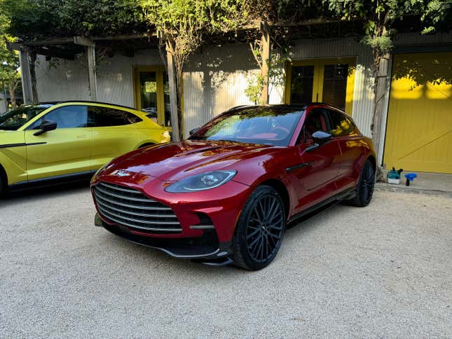 Front 3/4 view of a red Aston Martin DBX707