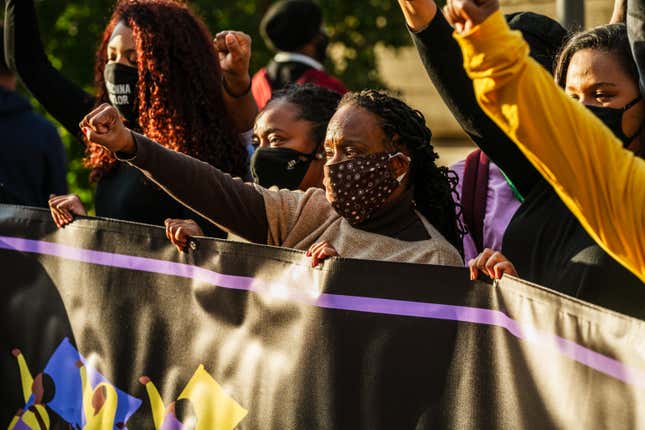  Demonstrators gather around Rep. Attica Scott (D-KY) and other members of the Black Women’s Collective during a march to the Breonna Taylor memorial at Jefferson Square Park on October 3, 2020, in Louisville, Ky. 