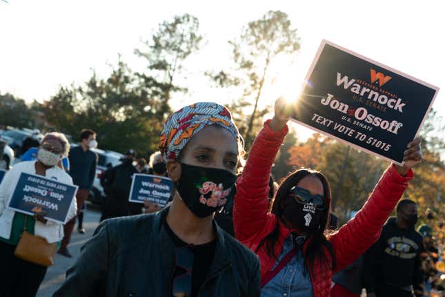 Attendees listen to a speaker at a rally for Democratic U.S. Senate candidates Raphael Warnock and Jon Ossoff on November 19, 2020 in Jonesboro, Georgia. Democratic U.S. Senate candidates Raphael Warnock and Jon Ossoff are campaigning in the state ahead of their January 5 runoff races against Sen. Kelly Loeffler (R-GA) and Sen. David Perdue (R-GA). 