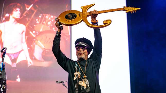 Spike Lee holds Prince’s guitar aloft at Prince: The Beautiful Ones—a Celebration of his Memoir, Life and Art at the Town Hall on Nov. 18, 2019