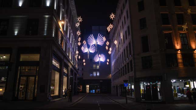 Festive lights light an empty street on December 20, 2020 in London, England. London and large parts of southern England were moved into a newly created “Tier 4&quot; lockdown, closing non-essential shops and limiting household mixing.