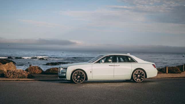 A photo of a pale blue Rolls Royce Ghost sedan. 