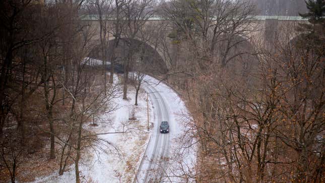 A car drives on a snow-covered road 