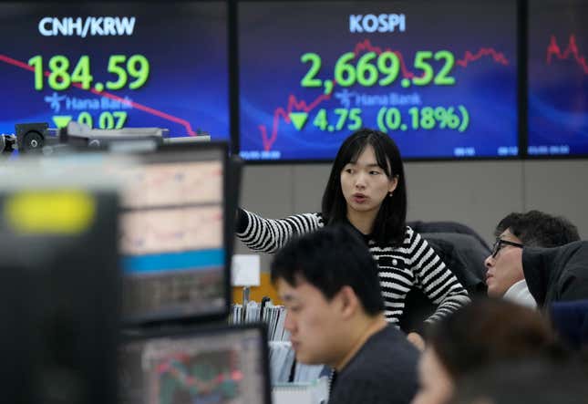 Currency traders watch monitors at the foreign exchange dealing room of the KEB Hana Bank headquarters in Seoul, South Korea, Tuesday, March 5, 2024. Shares were mixed Tuesday in Asia after China’s premier said the country’s target for economic growth this year is around 5%, in line with expectations. (AP Photo/Ahn Young-joon)