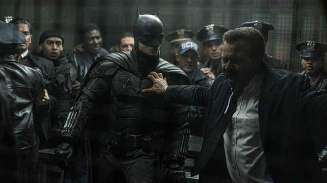 Gordon holding off cops from fighting batman.