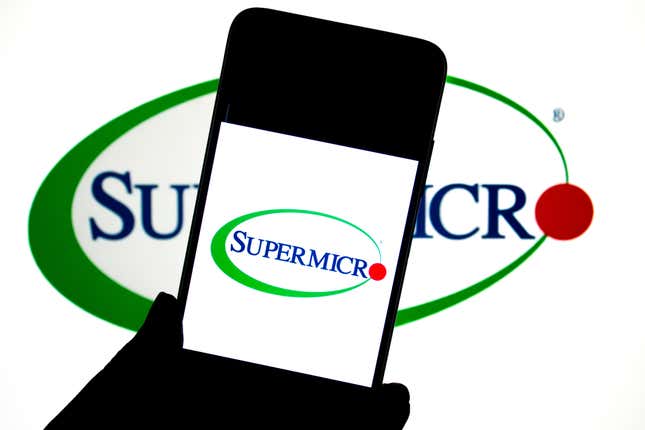 Super Micro logo seen displayed on a smartphone and in the background