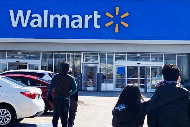 FILE - Shoppers walk to a Walmart in Vernon Hills, Ill., Tuesday, March 28, 2023. If you purchased some weighted groceries or bagged fruit at Walmart in recent years, you may be eligible for a cash payment from a class action settlement with the retailer. The class action lawsuit, which was first filed in October 2022, alleges that Walmart shoppers across the U.S. and Puerto Rico who purchased certain sold-by-weight meat and seafood as well as select citrus sold in bulk bags paid more than the lowest price advertised in stores.(AP Photo/Nam Y. Huh, File)