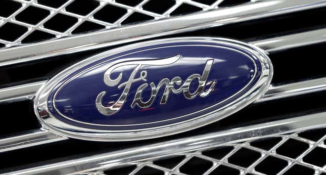 FILE - This Jan. 5, 2015, file photo shows a Ford logo shines on the front grille of a 2014 Ford F-150, on display at a local dealership in Hialeah, Fla. Ford Motor Co. and the United Auto Workers union have reached a tentative agreement on a local contract at the company’s most profitable factory, averting the threat of a strike. The union said last week said that nearly 9,000 workers at the Kentucky Truck Plant in Louisville would walk picket lines starting Friday if the contract dispute was not resolved. But the UAW said in a statement Wednesday that a deal had been reached, ending the strike threat. Workers still have to vote on the contract. (AP Photo/Alan Diaz, File)