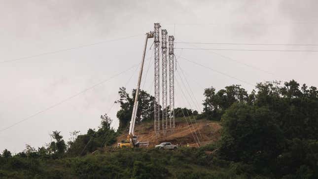 Electric company crews work on towers in Patillas, Puerto Rico, September 2018, a year after the devastating storm Hurricane Maria.