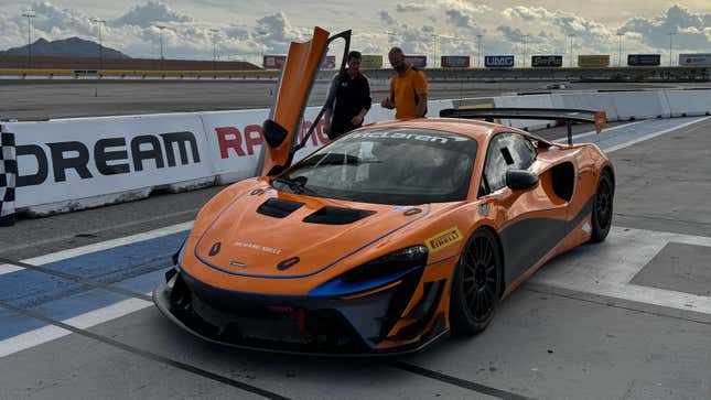 Front 3/4 view of an orange McLaren Artura Trophy race car