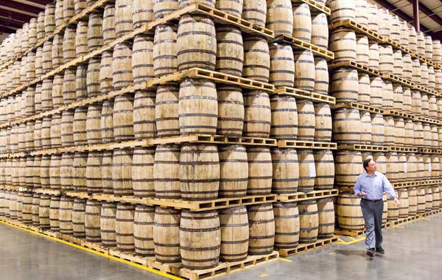 FILE - A Diageo employee walks by barrels of whiskey stored in a new warehouse at the George Dickel distillery near Tullahoma, Tenn. on Aug. 14, 2014. Spirits and beer giant Diageo saw billions wiped off its market value on Friday, Nov. 10, 2023 after it warned that a sharp slowdown in its business in Latin America and the Caribbean was hitting sales and potential profits. In early trading in London, the company’s share price was down by 14% after it told investors that it expects growth in the first half of the current financial year to be slower than the previous half-year (AP Photo/Erik Schelzig, File)