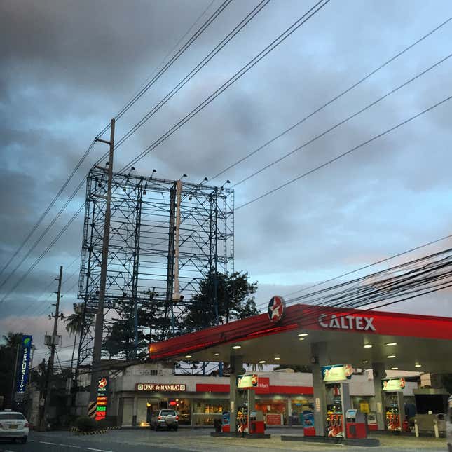 Image for article titled Photos: Dismantled billboards, ghostly scaffolds as a city braces for a typhoon