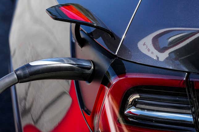 File - A Tesla vehicle receives a charge at a charging station, Sept. 28, 2023, in Woodstock, Ga. Tesla is expected to report fourth quarter and full year sales Tuesday as electric vehicle sales growth continues to slow. (AP Photo/Mike Stewart, File)