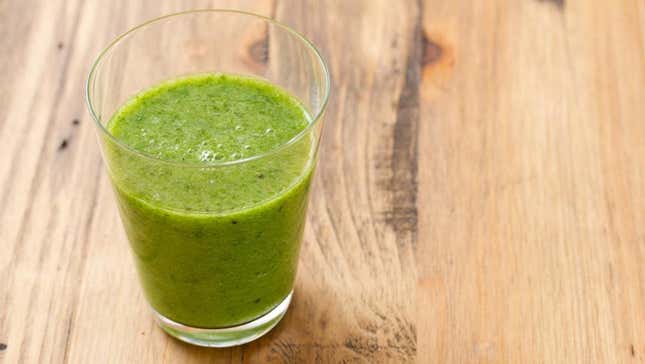 Basil smoothie in glass on table