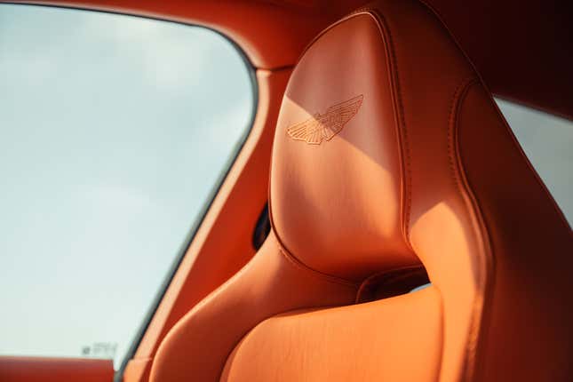 Front seat headrest of an orange 2025 Aston Martin DBX707