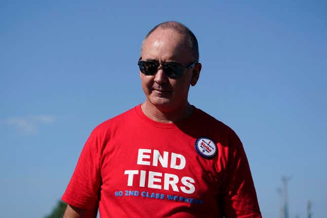 File - United Auto Workers President Shawn Fain walks in the Labor Day parade in Detroit, Monday, Sept. 4, 2023. Fain is scheduled to update members Wednesday on plans to strike against the Detroit Three automakers if no contract agreements are reached by a Thursday night deadline. (AP Photo/Paul Sancya, File)