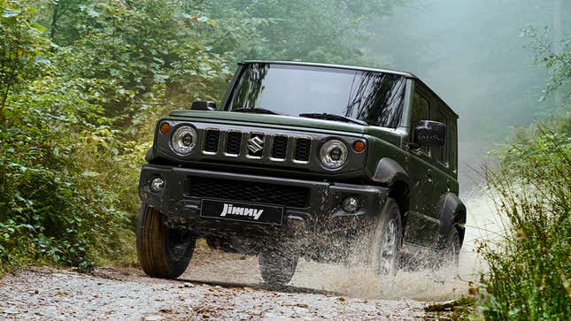 a dark green jimny nomade driving through mud offroad