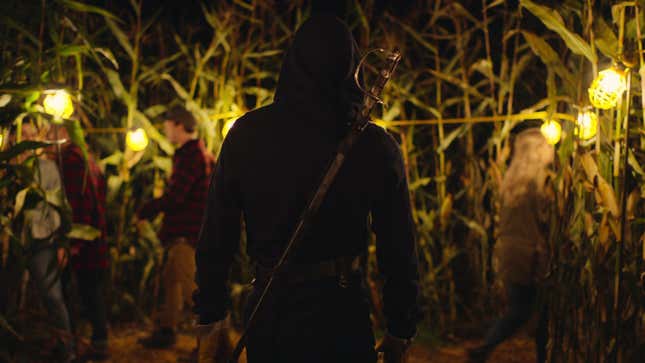 A mysterious killer stands in a corn maze with their back to the camera in There's Someone Inside Your House.