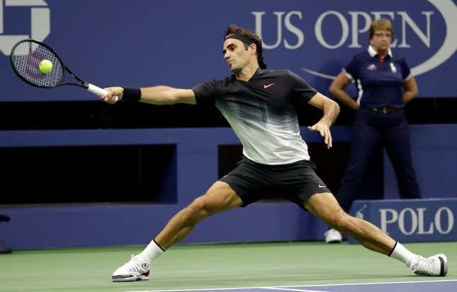 Roger Federer, of Switzerland, stretches to return a shot to Frances Tiafoe, of the United States, during the U.S. Open tennis tournament, Tuesday, Aug. 29, 2017, in New York. (AP Photo/Julio Cortez)