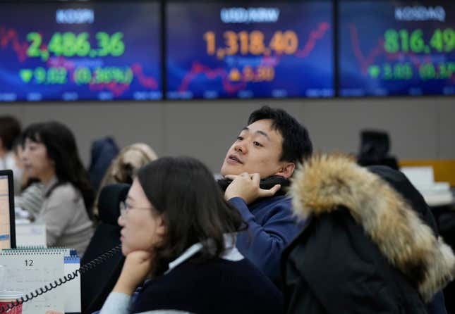 A currency watches monitors at the foreign exchange dealing room of the KEB Hana Bank headquarters in Seoul, South Korea, Thursday, Dec. 7, 2023. Shares fell Thursday in Asia after a retreat on Wall Street as crude oil prices slipped on expectations that supply might outpace demand. (AP Photo/Ahn Young-joon)