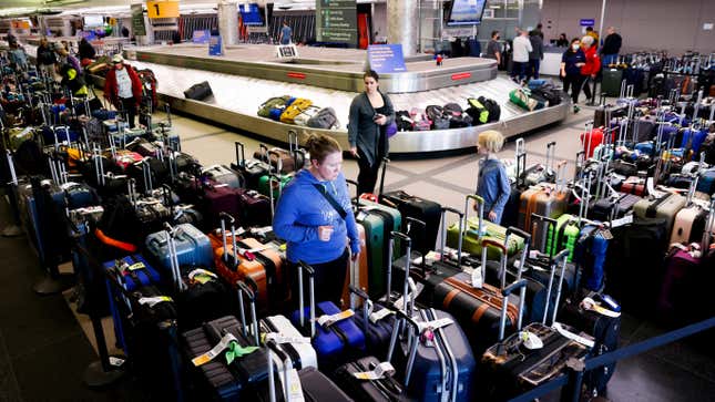 Travelers search for their suitcases in a baggage holding area for Southwest Airlines at Denver International Airport on December 28, 2022 in Denver, Colorado. 