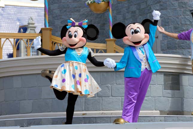 FILE - Minnie and Mickey Mouse perform for guests during a musical show in the Magic Kingdom at Walt Disney World Friday, July 14, 2023, in Lake Buena Vista, Fla. Disney on Tuesday, Nov. 14, released a study showing its economic impact in Florida at more than $40 billion, as it battles in courts with Florida Gov. Ron DeSantis and his appointees over their takeover of the district that governs the entertainment company&#39;s massive resort in central Florida.(AP Photo/John Raoux, File)