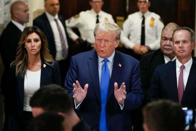 Former President Donald Trump, center, speaks to the media upon arriving at New York Supreme Court, Monday, Oct. 2, 2023, in New York. Trump is making a rare, voluntary trip to court in New York for the start of a civil trial in a lawsuit that already has resulted in a judge ruling that he committed fraud in his business dealings. (AP Photo/Seth Wenig)