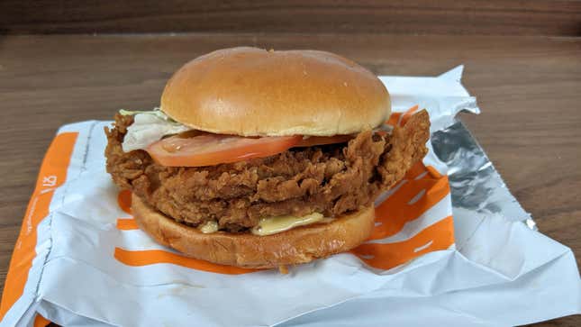 Burger King's hand-breaded Ch'King sandwich with lettuce and tomato sitting atop serving pouch