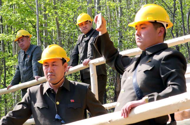 North Korean officials watch the dismantlement process of Punggye-ri nuclear test ground in Punggye-ri, North Hamgyong Province, North Korea May 24, 2018. Picture taken May 24, 2018.