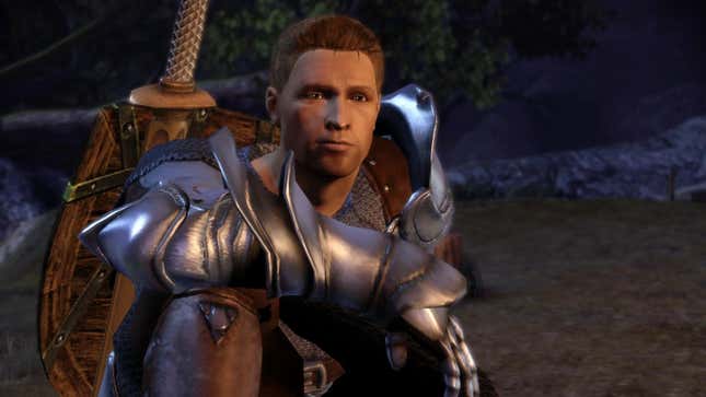 Alistair sits next to a campfire.