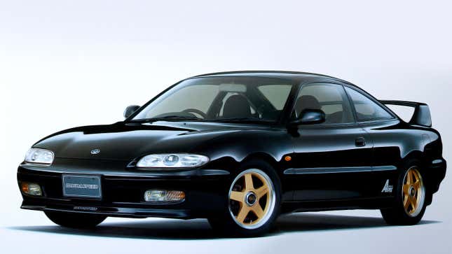 A black Mazda MX-6 coupe. 