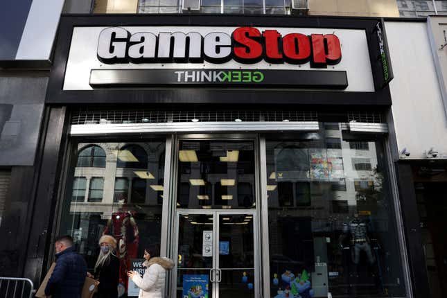 People walk by a GameStop in Manhattan, New York, U.S., December 7, 2021