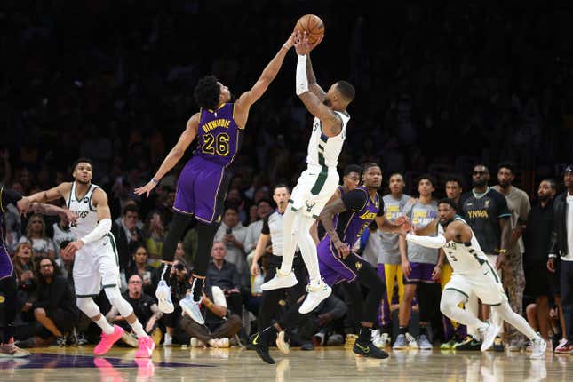 LOS ANGELES, CALIFORNIA - MARCH 08: Spencer Dinwiddie #26 of the Los Angeles Lakers blocks a shot by Damian Lillard #0 of the Milwaukee Bucks during the final seconds of the  second half of a game at Crypto.com Arena on March 08, 2024 in Los Angeles, California. (Photo by Sean M. Haffey/Getty Images)