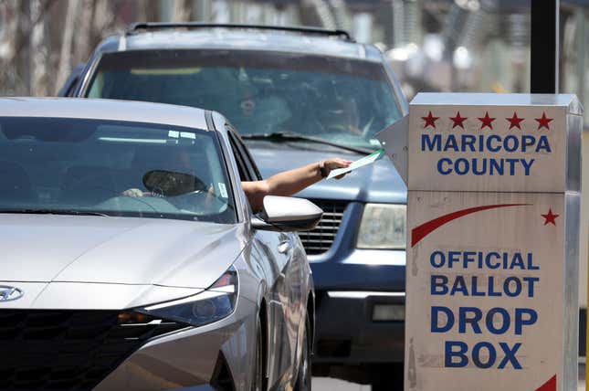 PHOENIX, ARIZONA - AUGUST 02: A voter places a ballot in a drop box outside of the Maricopa County Elections Department on August 02, 2022, in Phoenix, Arizona. Arizonans are heading to the polls to vote in the state’s midterm primary election.