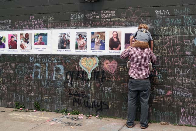 People gather at a memorial for the shooting victims outside of Tops grocery store on May 20, 2022, in Buffalo, New York. 18-year-old Payton tenndron is accused of the mass shooting that killed ten people at the Tops grocery store on the east side of Buffalo on May 14th and is being investigated as a hate crime. 